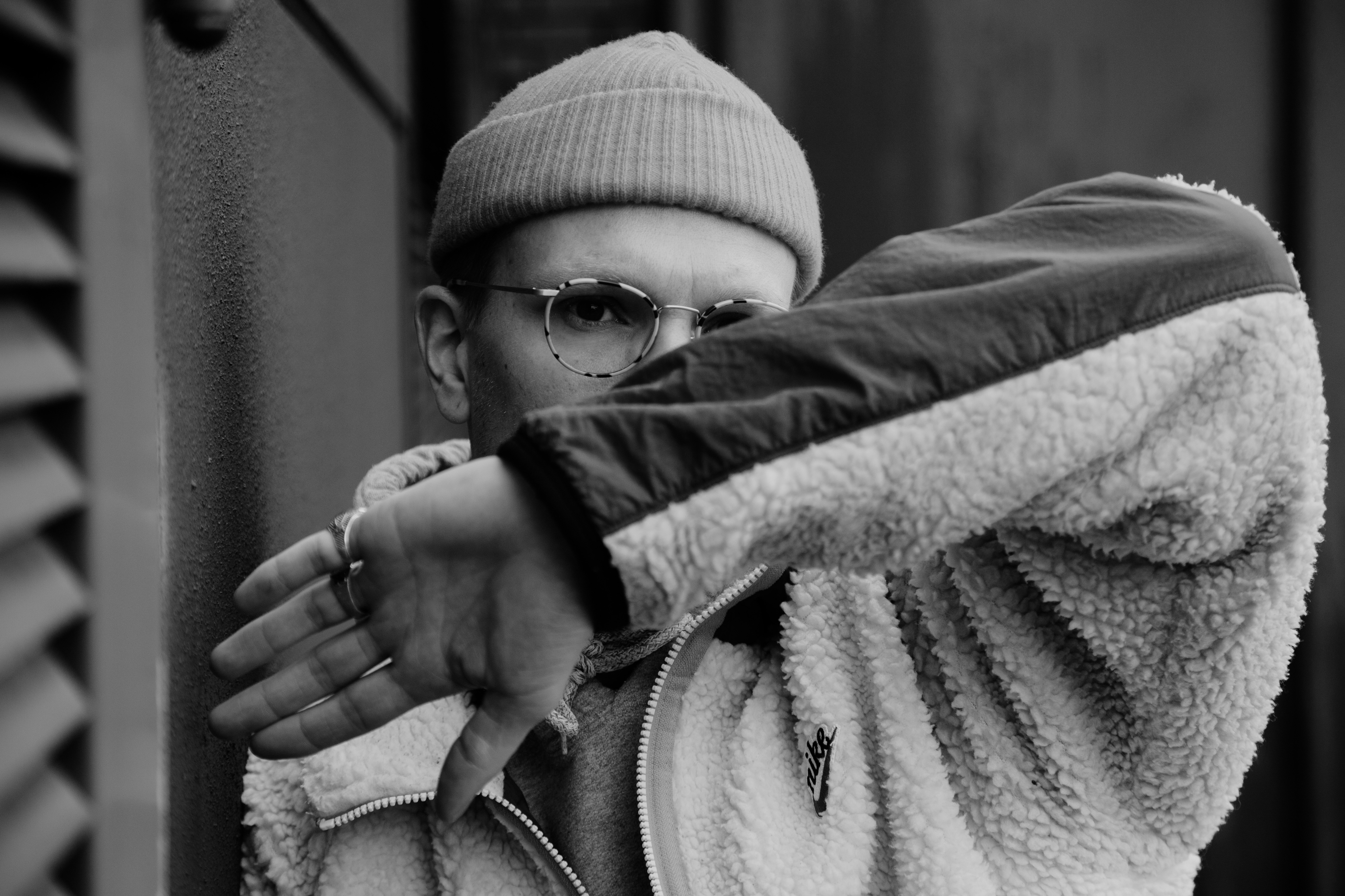 grayscale photo of child wearing knit cap and eyeglasses